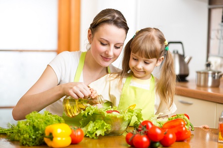 a woman cooking with her daughter